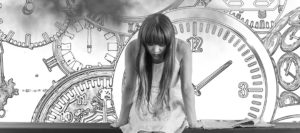 Woman contemplating lack of busyness strategy - bowed down surrounded by clocks